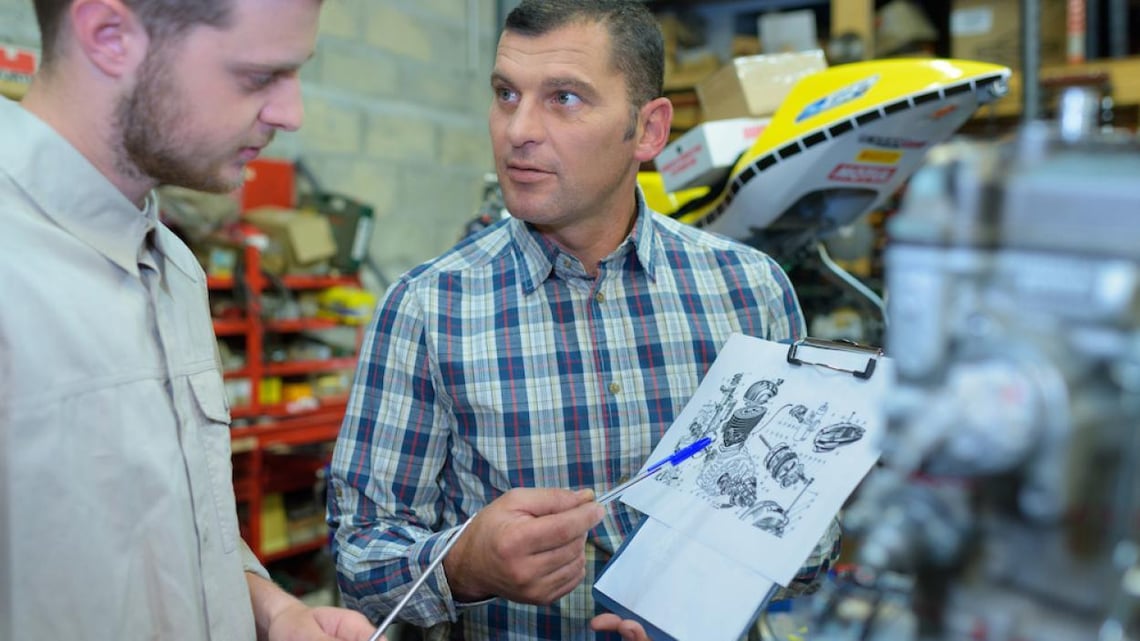 man showing another man a design